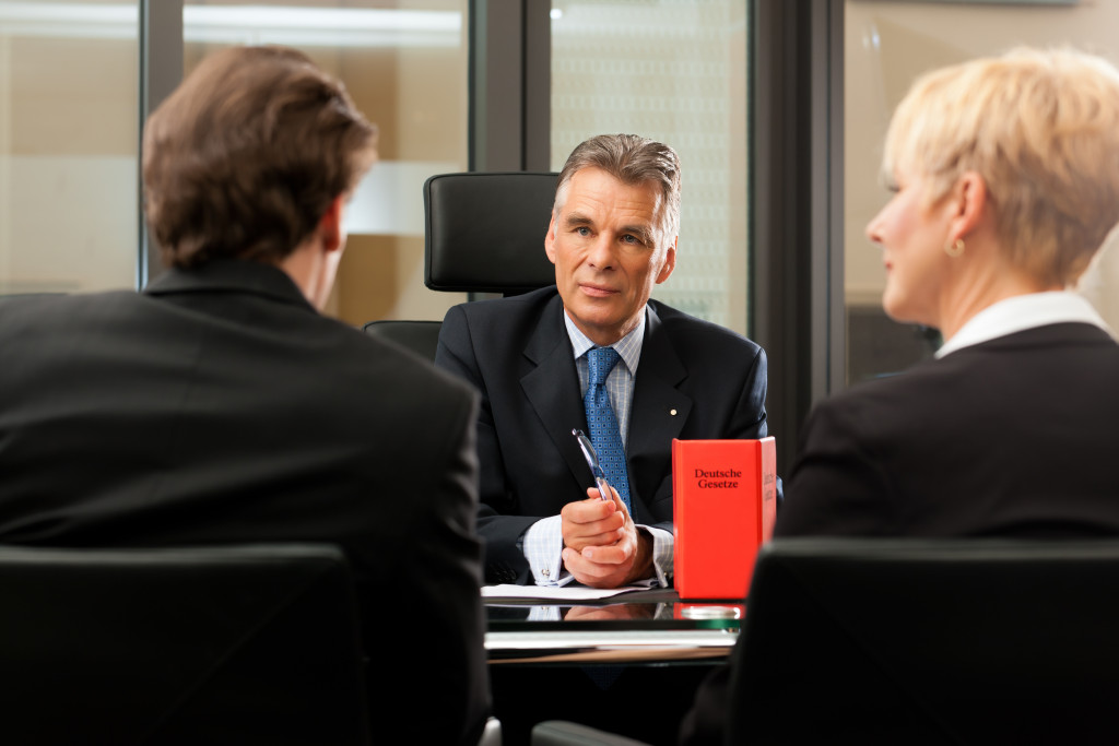 lawyer or notary with clients in his office in a meeting